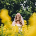 bride-in-field-of-yellow-flowers