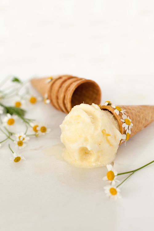 ice cream cones with pineapple chamomile sorbet and flowers surrounding it