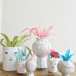 Paper plants in faces vases