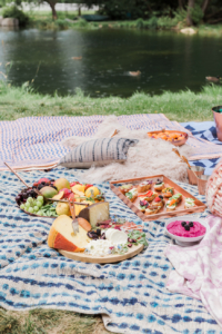 A fancy summer picnic next to a pond.