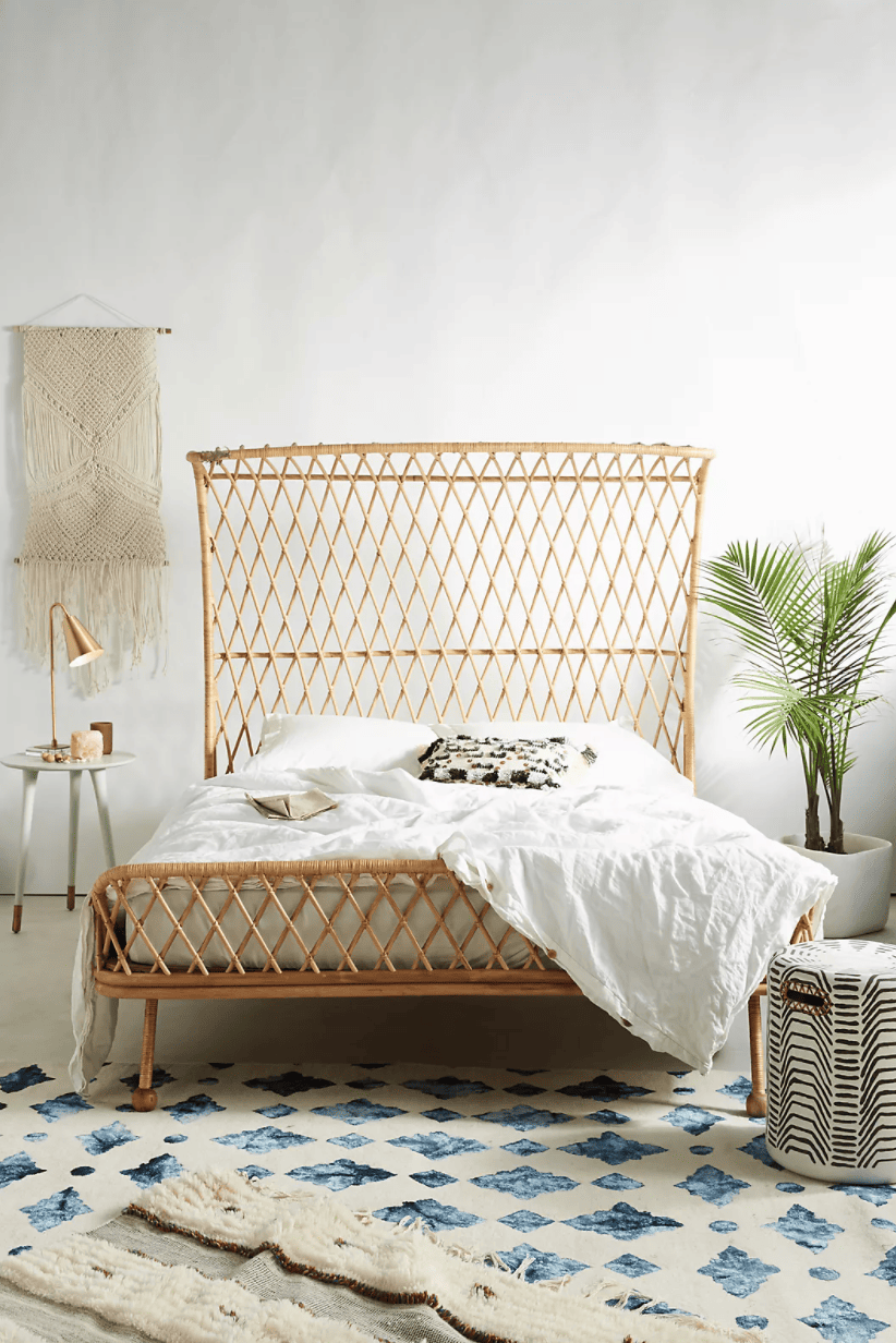Dramatic Rattan bed with a criss-crossing rattan headboard