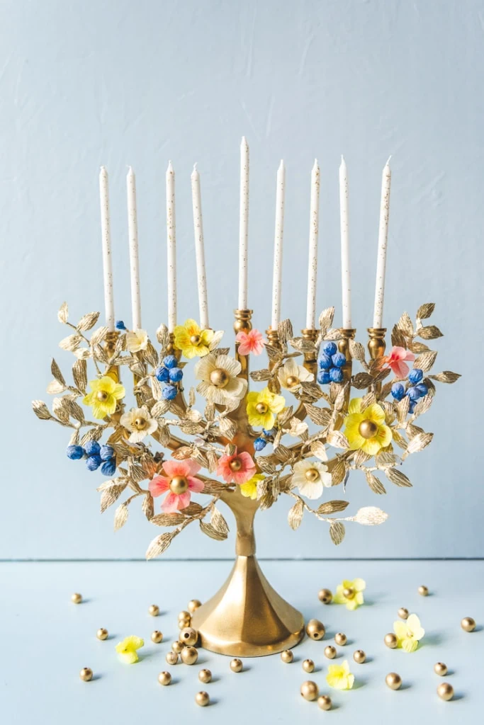 Gold, blue, yellow, and pink paper flower menorah