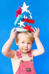 Jasper wears a 4th of July sponge crown and red overalls.