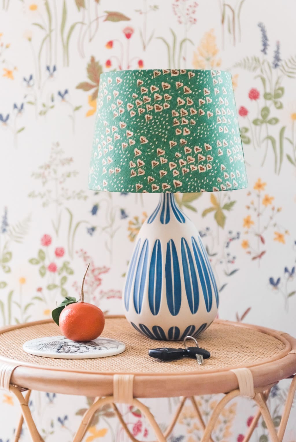 Lamp customized with spoonflower fabric from Holli Zollinger against a wildflower covered wall.