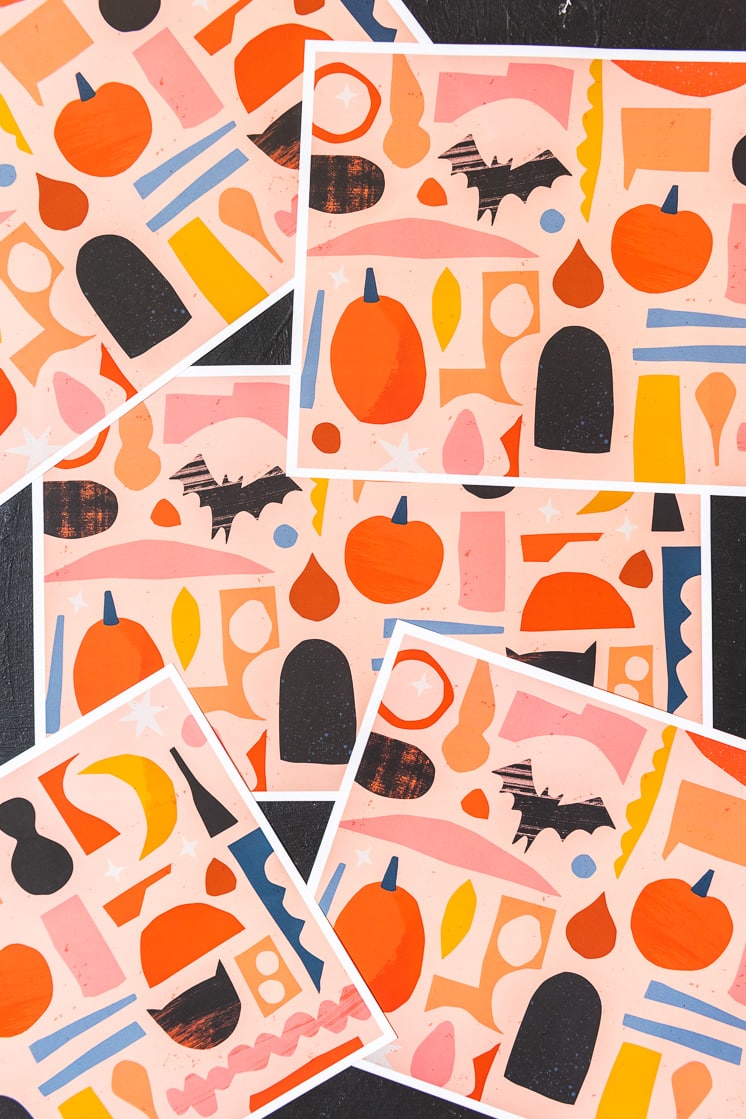 Paper party goods with a halloween theme on a black background. They're orange, yellow, black, white, navy, and peach.