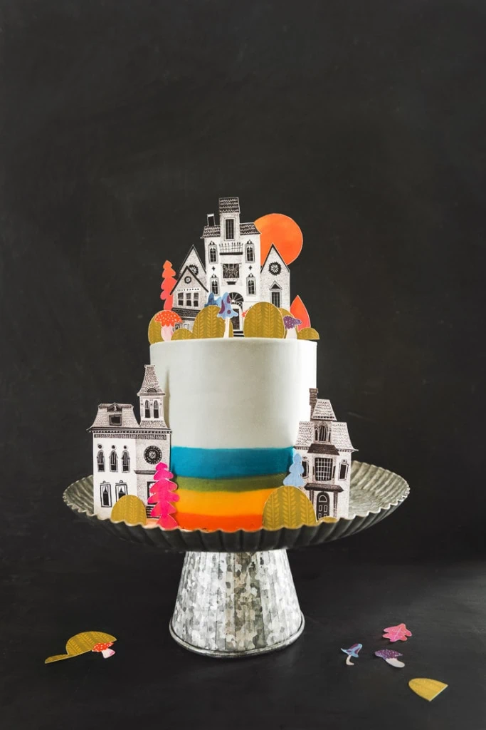 a colorful, cute printable cake topper set on a cake.