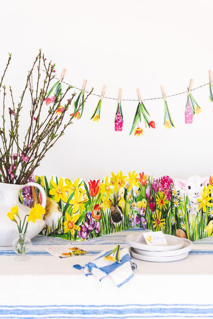 Easter printable tablescape with flowers and rabbits and a floral garland.