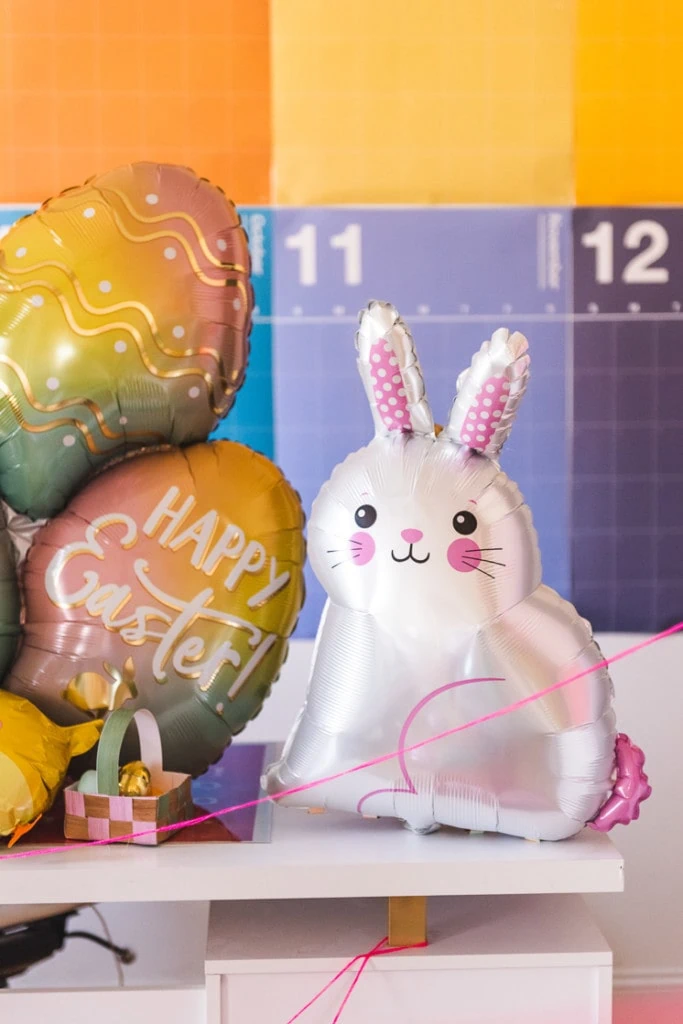 Photo of an Easter bunny balloon in a colorful room.