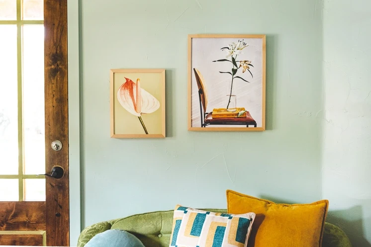 Floral prints by Chaunte Vaughn on a mint green wall