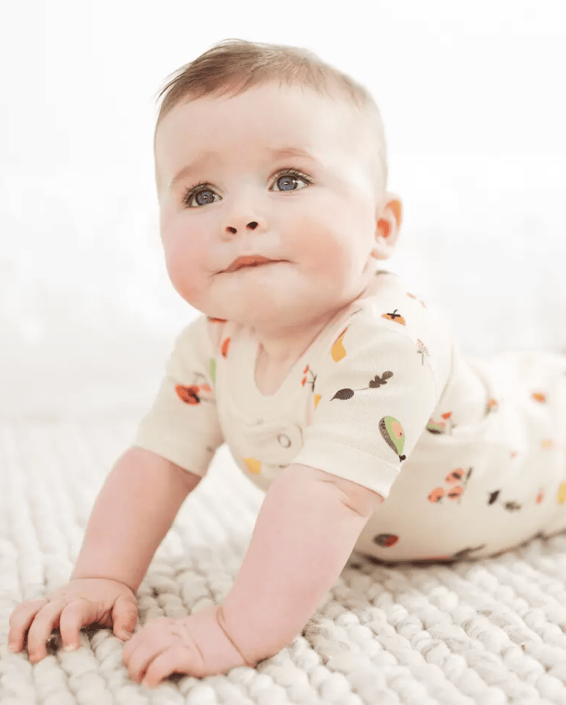 Baby wearing a short-sleeved veggie print sleeper