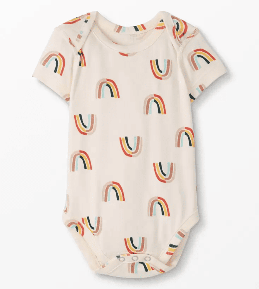 Baby wearing a short-sleeved veggie print sleeper
