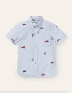 Blue button up shirt with cars and trucks embroidered on it