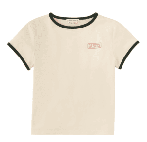 Cream colored unisex tshirt with black binding on the collar and sleeves and small red words in a rectangle reading "the sunday collective."