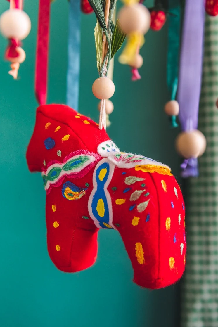 Close up of a colorful chandelier with a hanging Dala horse is i