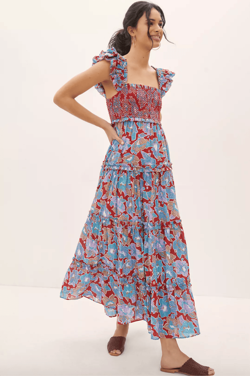 A smocked red and blue floral dress with ruffled sleeves and a smocked bodice