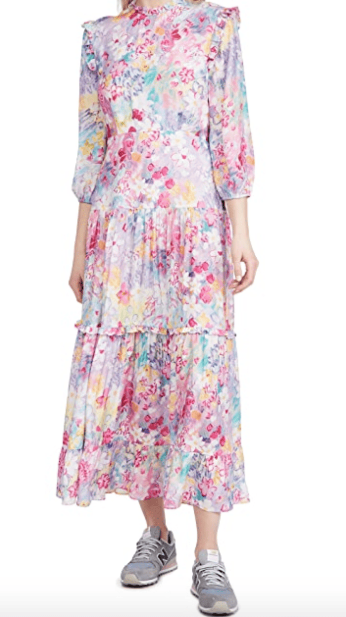 A painterly printed tiered dress in pink with purple, yellow, aqua, and orange accents.