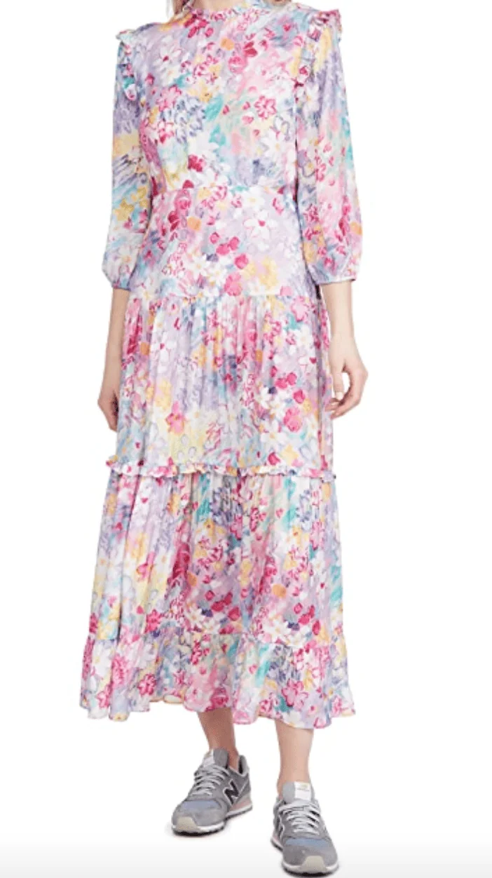 A painterly printed tiered dress in pink with purple, yellow, aqua, and orange accents.