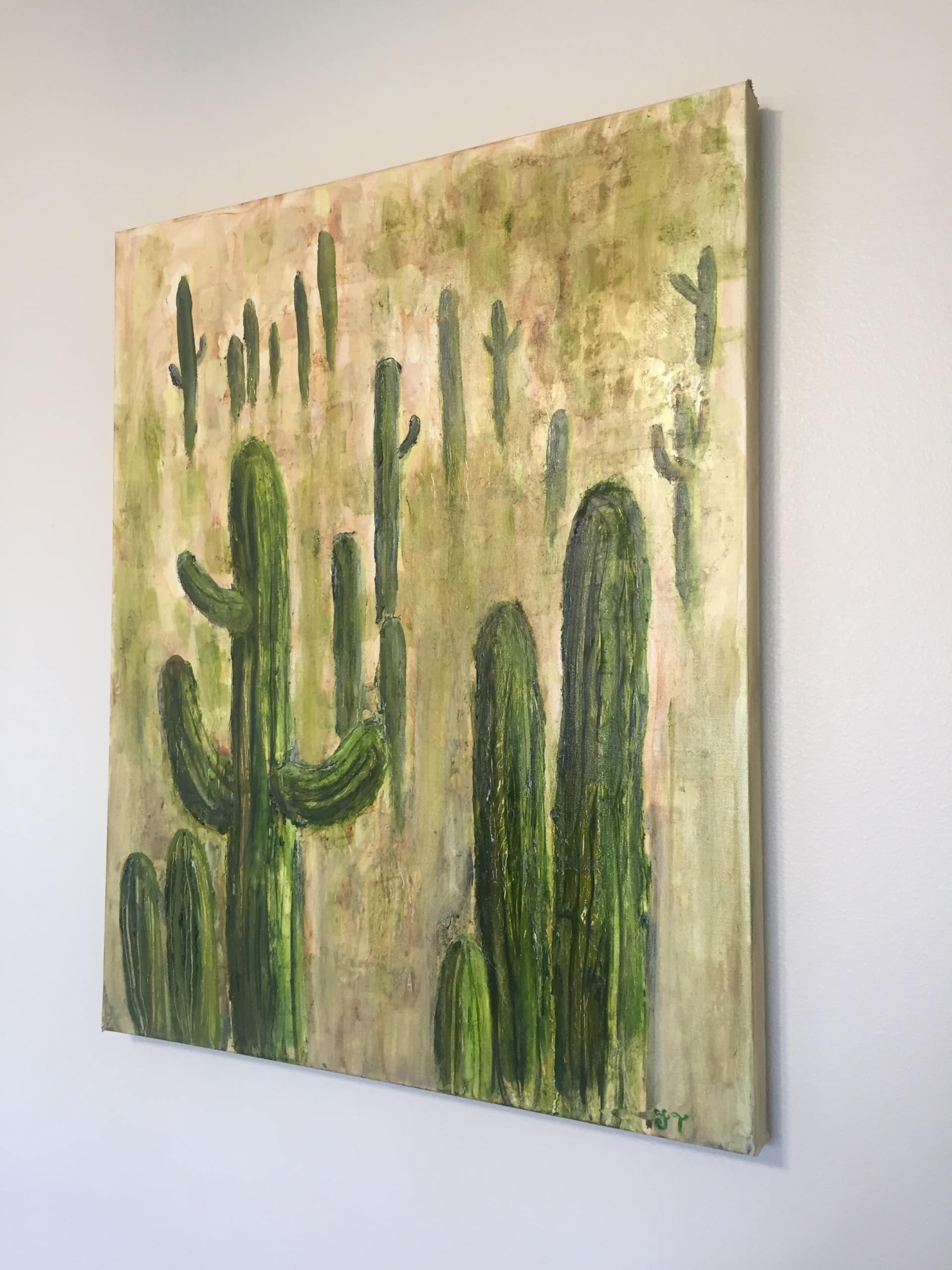 A finished painting of saguaro cactuses. 
