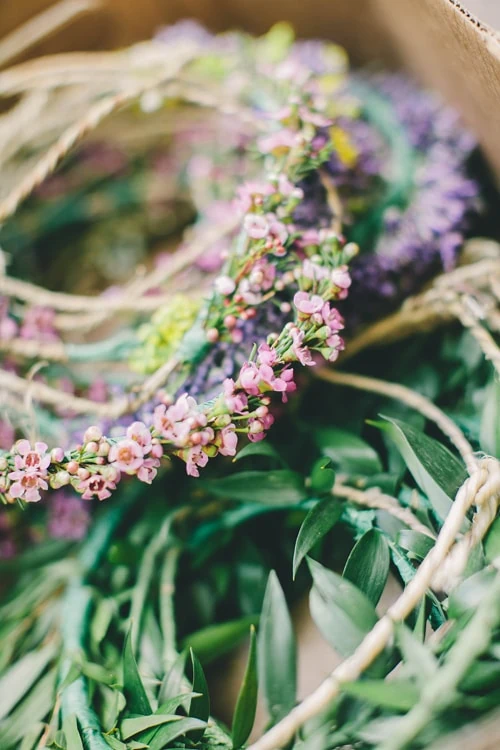 waxflower and laurel flower crowns are stacked in a pile.