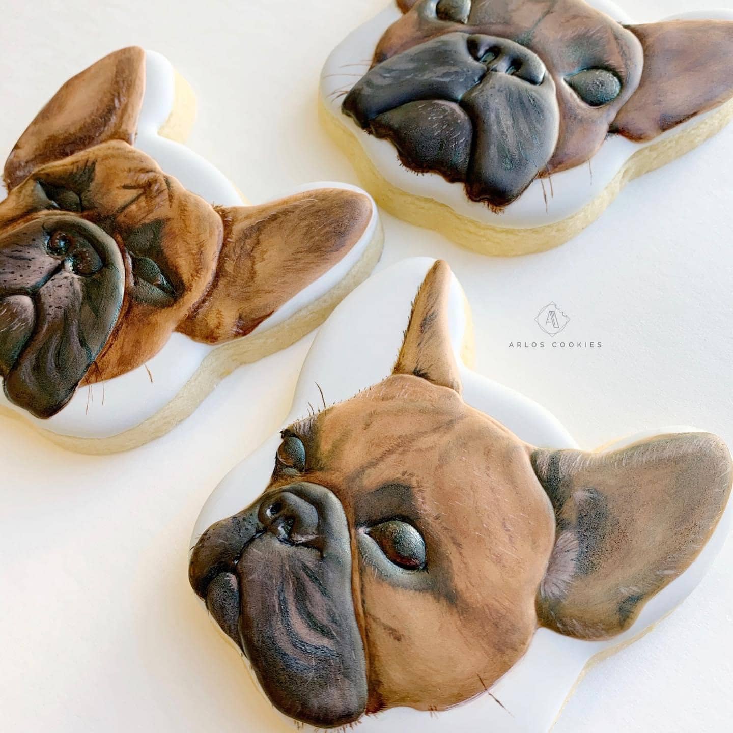 Hyperrealistically painted cookies featuring a dog.