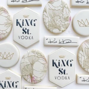 Cookies decorated with floral line drawings and the King St. Vodka logo