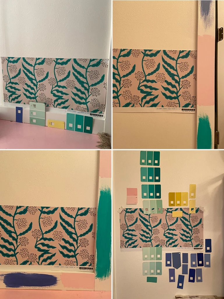 Progress shots from testing out various paint colors. The green vined wallpaper is taped up with paint samples in pink, green, yellow, and blue around it.