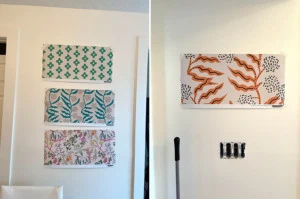 Two photos of the wallpaper samples stuck to the white office wall.