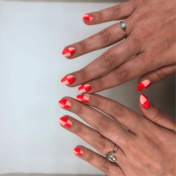 Hailey shows pink and red checkerboard nails.