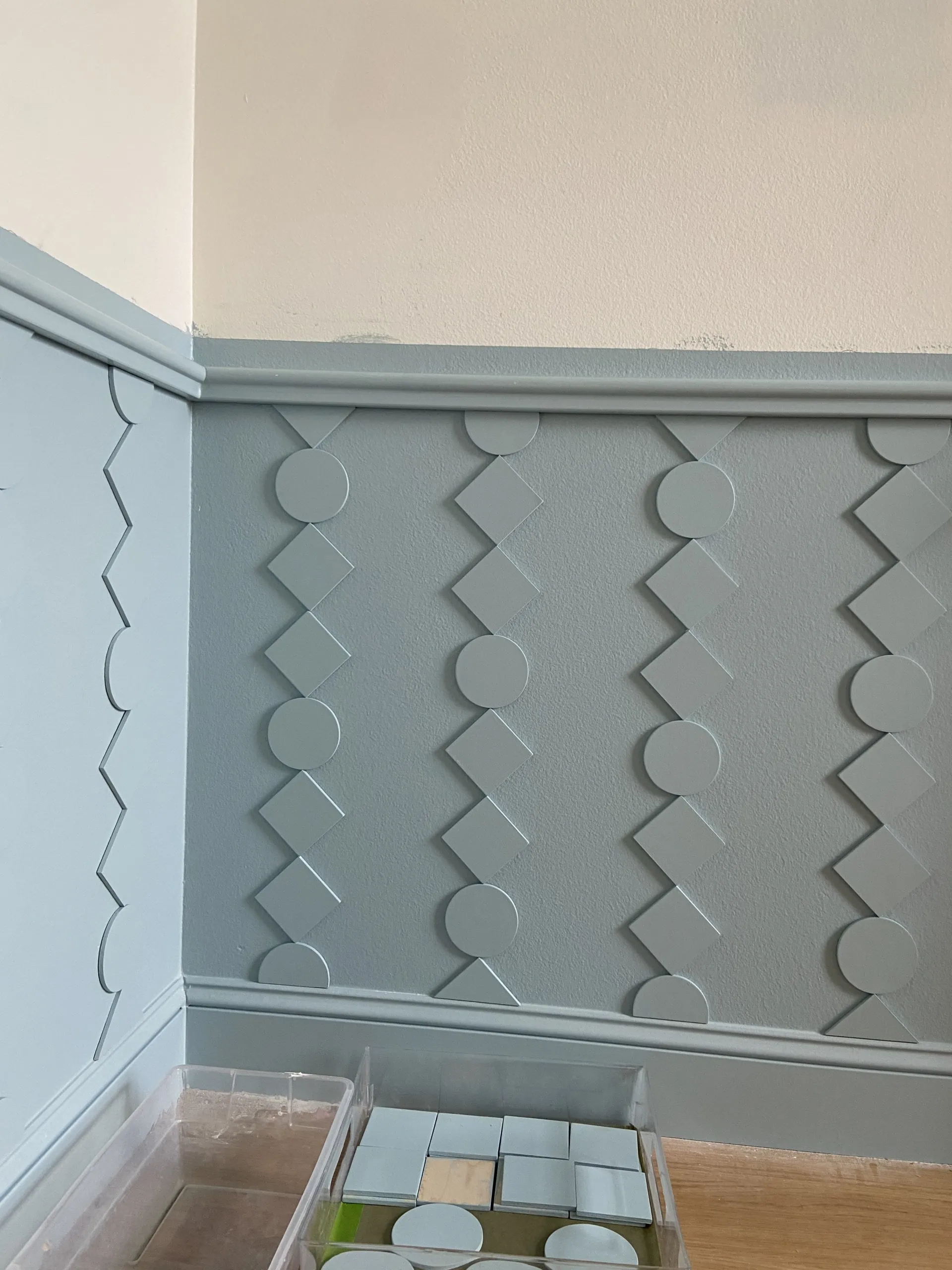 DIY custom wainscoting installed in a blue and white room.