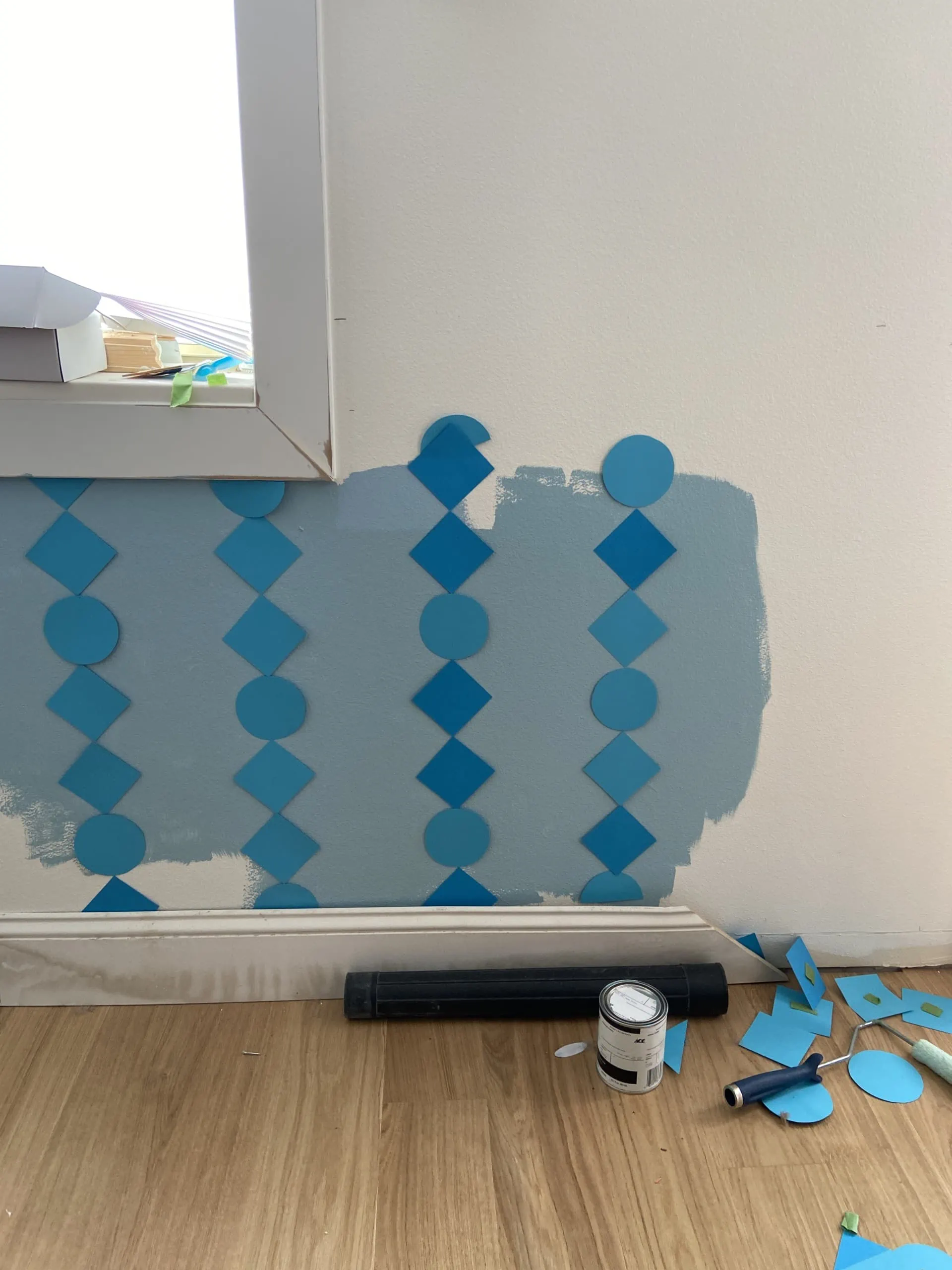 Paper mockup of DIY wainscoting on a white and blue wall.