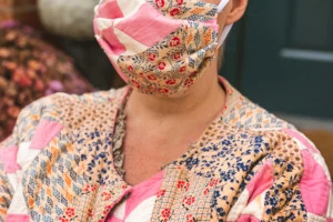 Closeup of Brittany wearing her quilted coat and face mask.