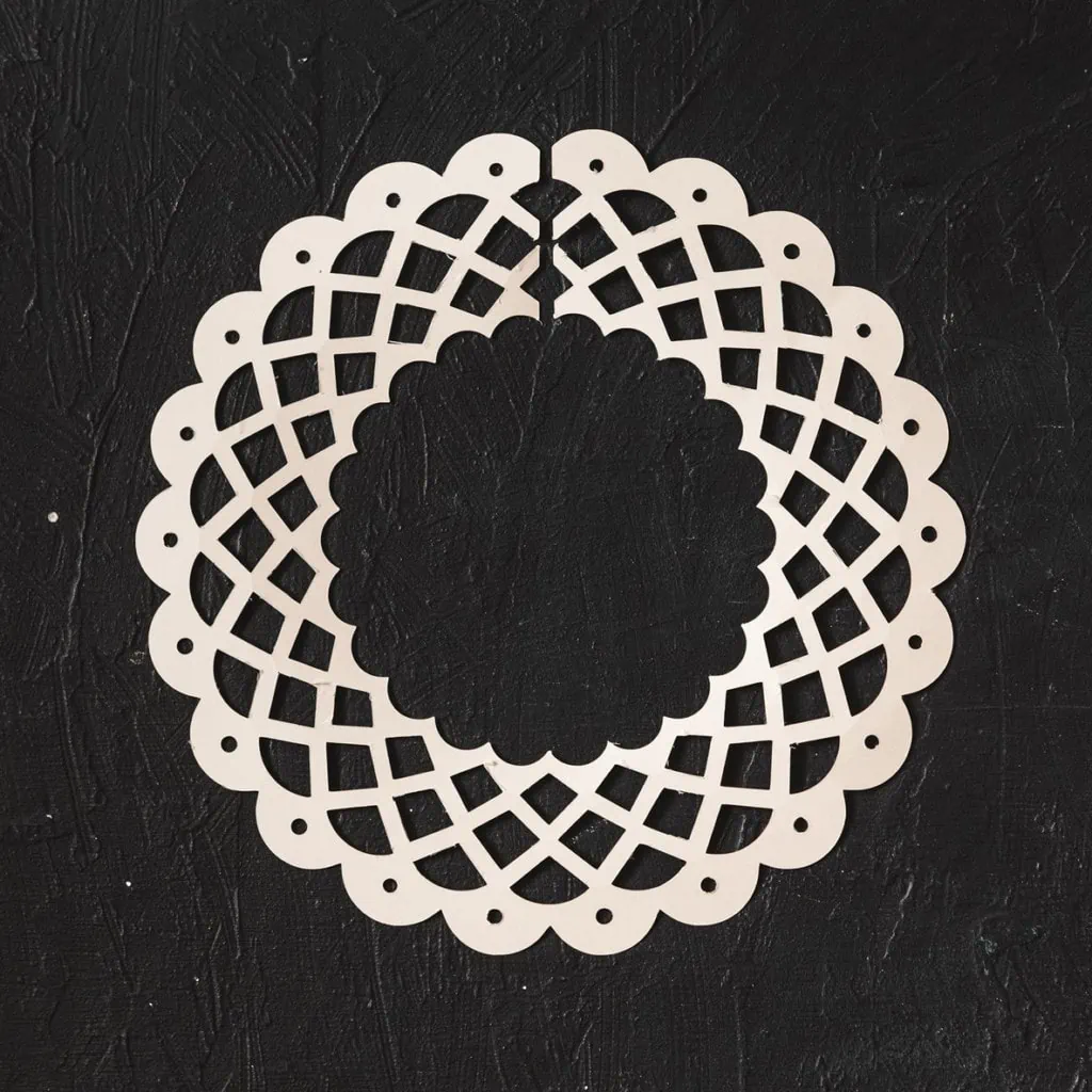 A white paper lace collar on a black background.