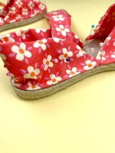 pinning fabric to espadrille soles with red daisy fabric