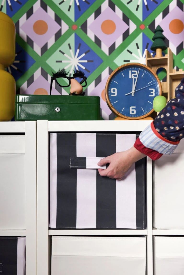 fabric covered toy bins in maximalist toy room