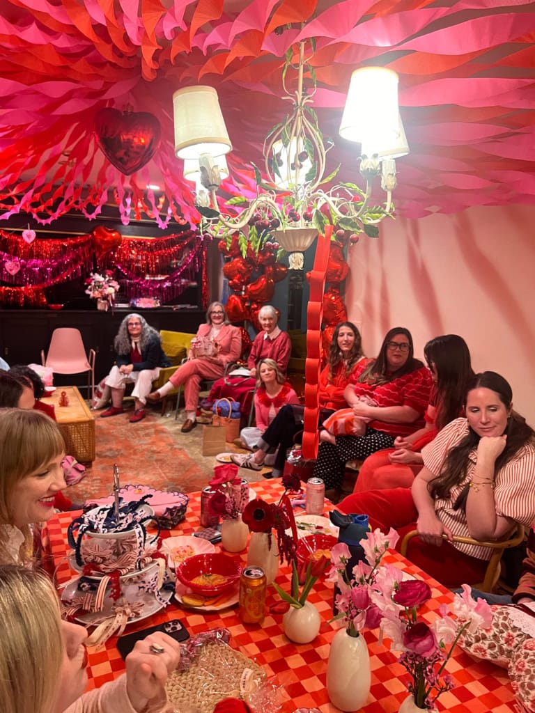 Colorful crepe paper circus tent decoration with guests enjoying the event.