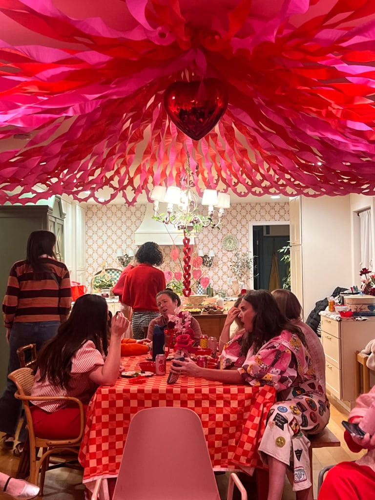 Colorful crepe paper circus tent decoration with pink and red hues.