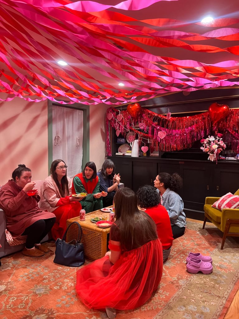 Crepe paper circus tent decoration with pink and red streamers for a festive party.