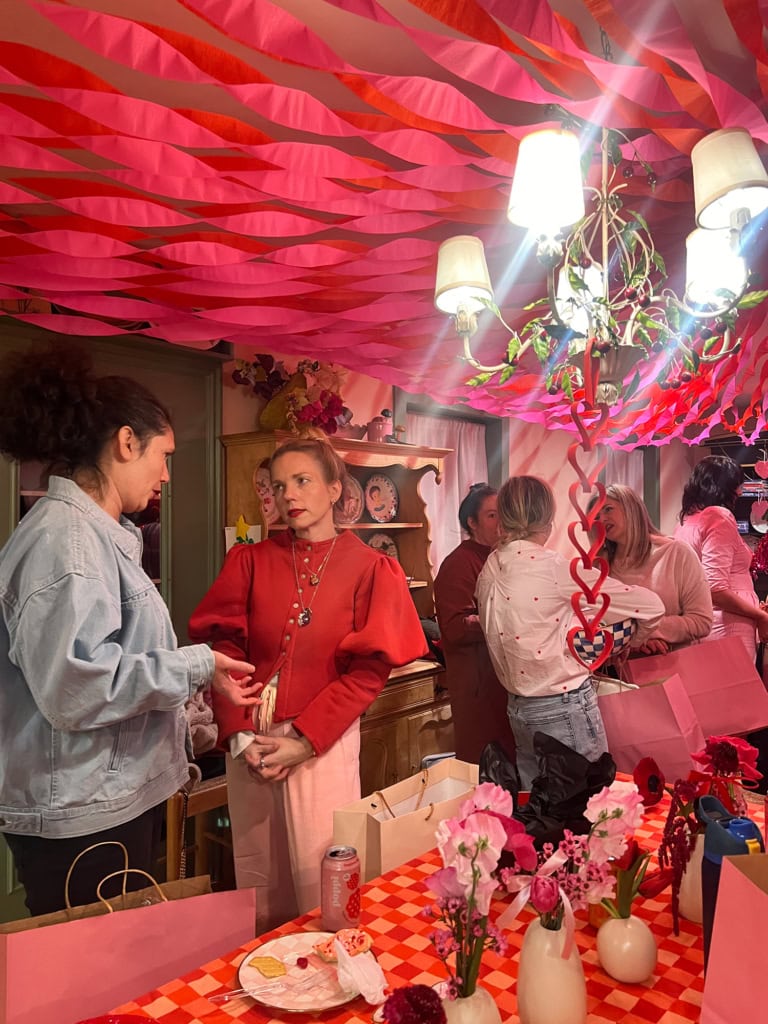 Vibrant crepe paper circus tent decoration with pink and red tones.